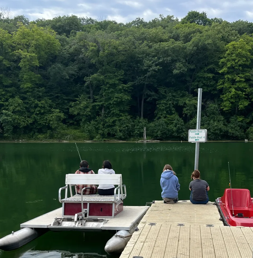 Group of people fishing off a dock