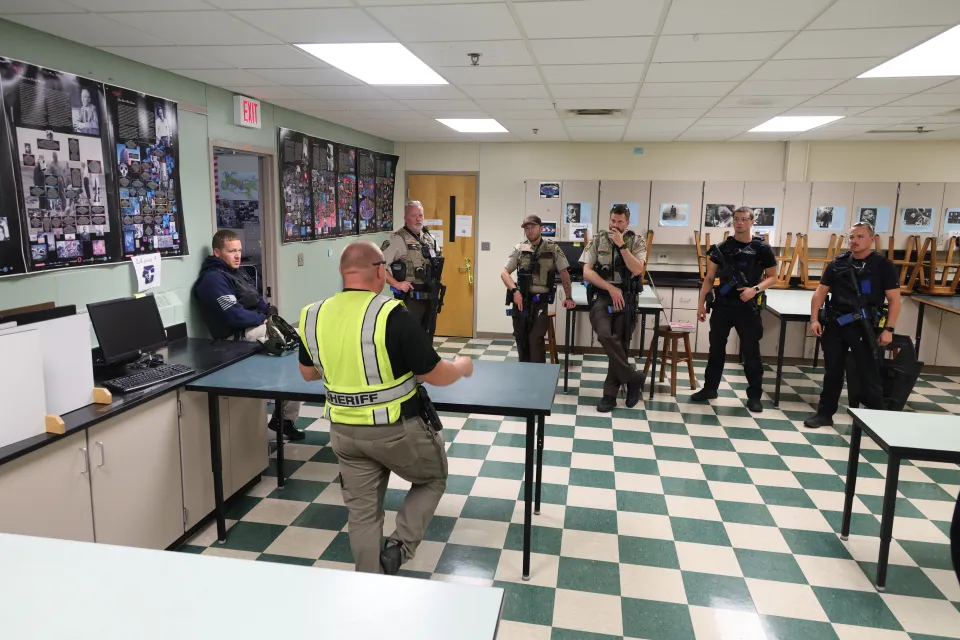 Members of the Sheriff's Office discuss active shooter training following an exercise. 