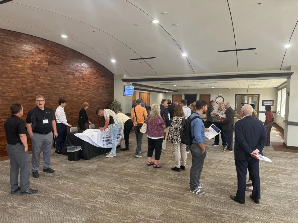 Crowd standing at transportation meeting
