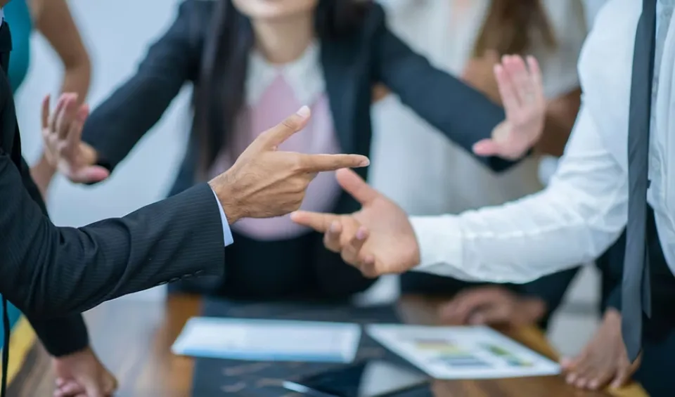 People pointing at one another.