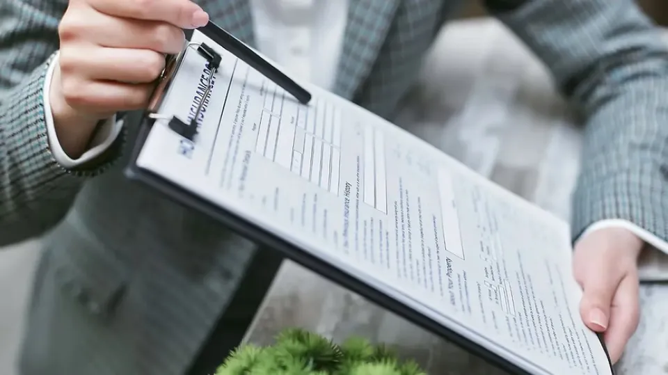 Person holding a clipboard.