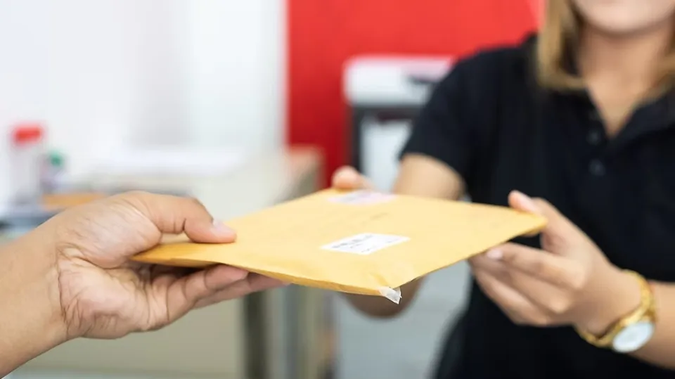 Person handing over an envelope. 