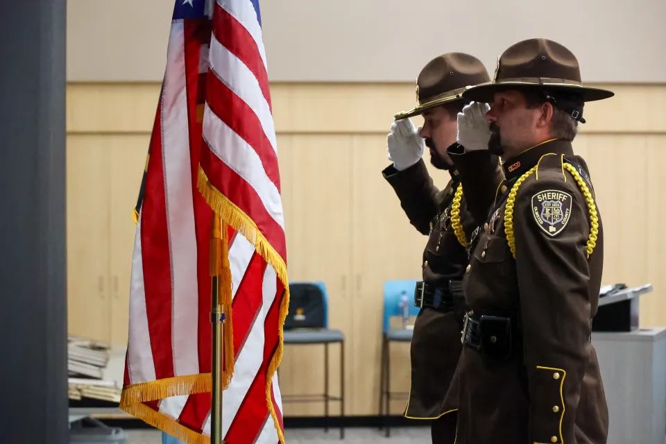 Members of the Olmsted County Sheriff's Office Honor Guard post colors (United States and Minnesota flag) prior to the event.