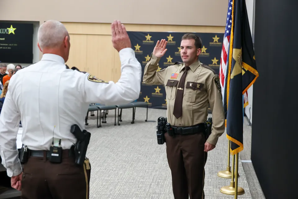 A new deputy sheriff is publicly sworn in by Sheriff Torgerson.