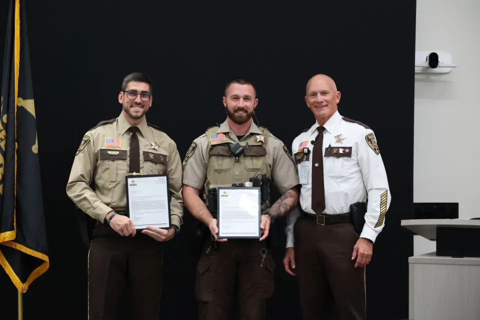 Deputies stand with Sheriff Torgerson after receiving their Letters of Recognition.