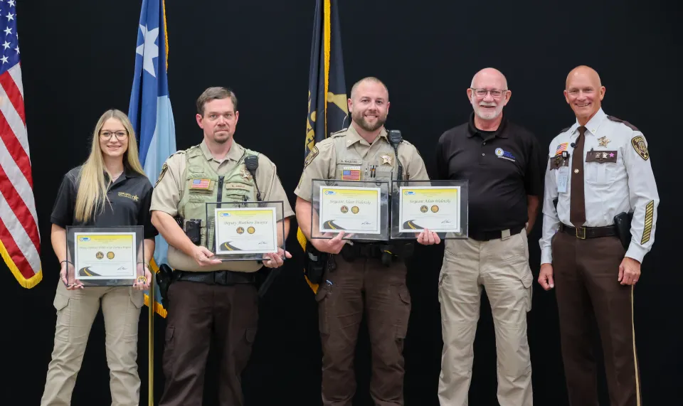 Members of the sheriff's office are awarded challenge coins from the Office of Traffic Safety.