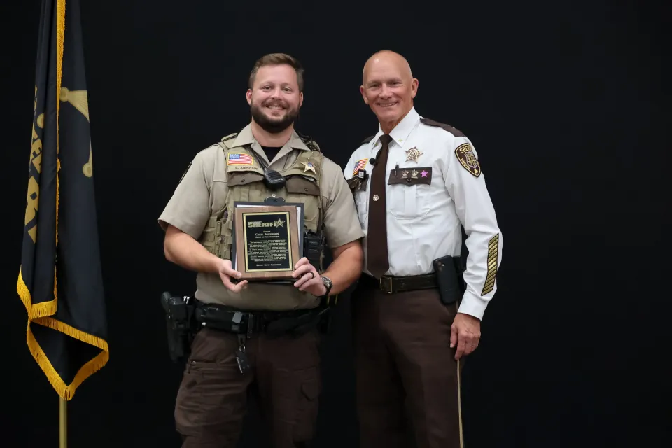 Deputy Chris Anderson stands with Sheriff Torgerson after receiving the Medal of Commendation.. 