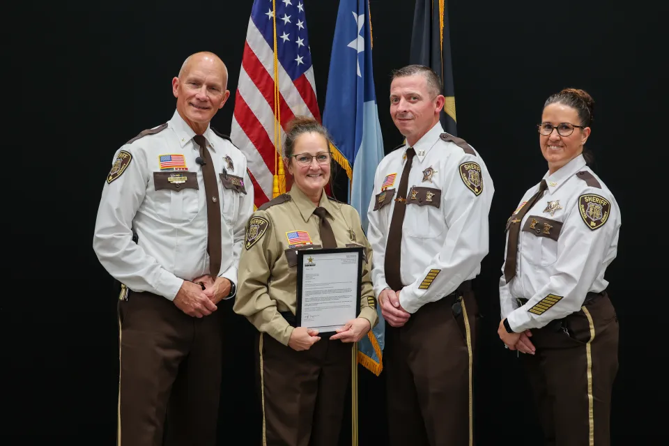 Members of the Sheriff's Office pose for a photo on stage
