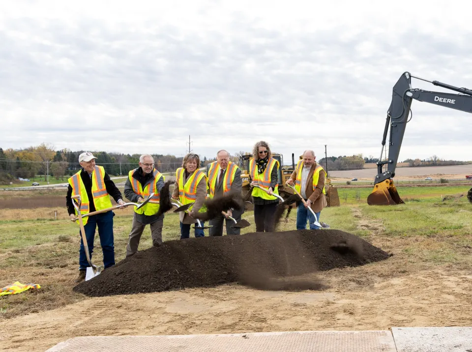 Board of commissioners shoveling dirt