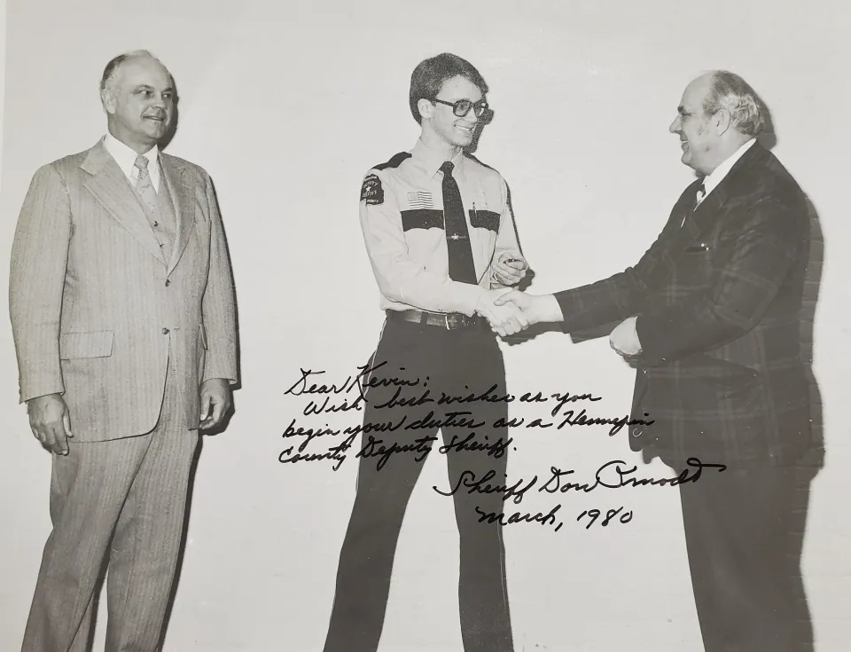 New deputy being sworn in by Sheriff back in the 1970s in black and white.