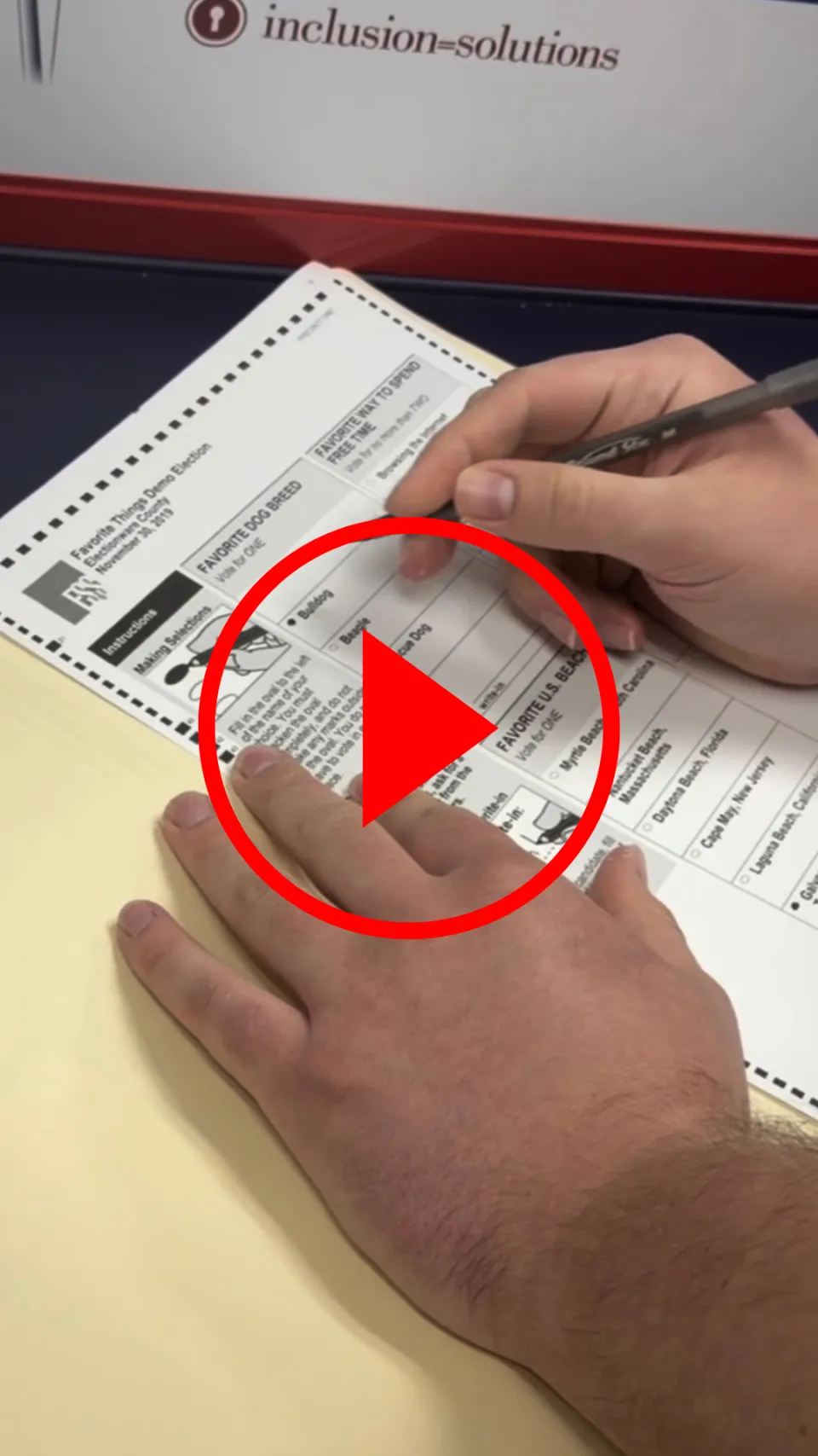 Hands filling out ballot with YouTube play button overlayed