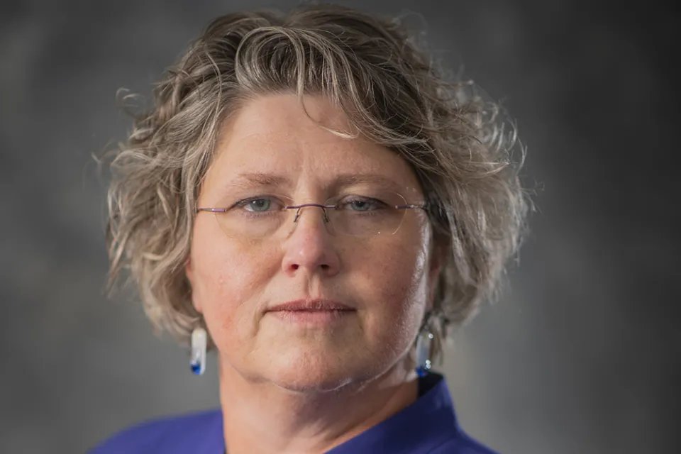 Headshot of Heidi Welsch, County Administrator, a white woman wearing a dark purple blazer and glasses