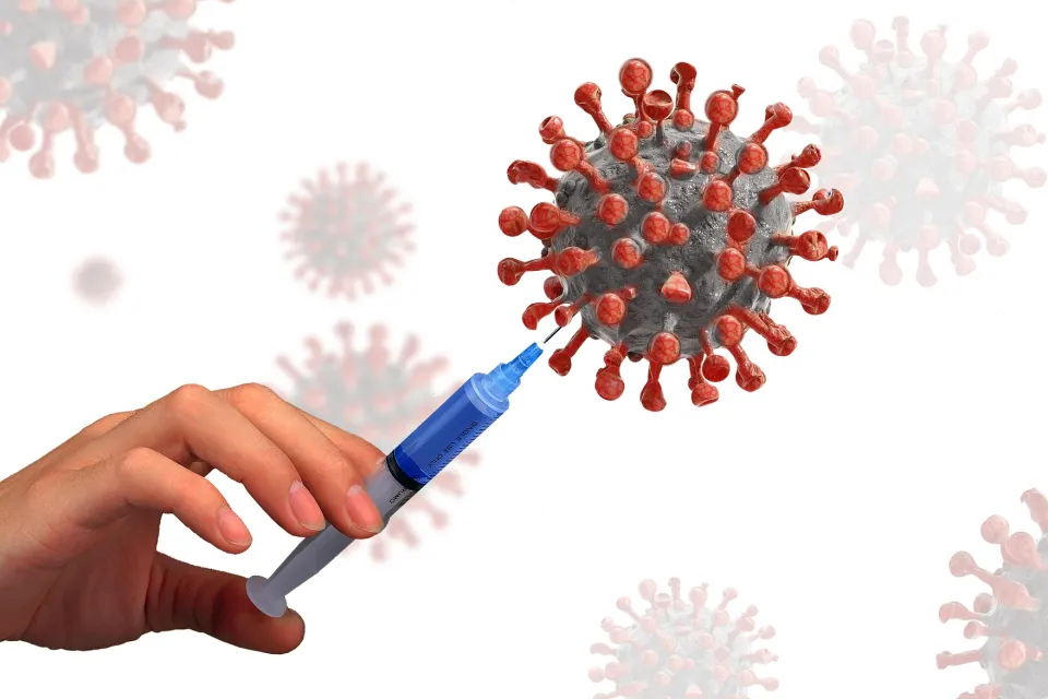 A vaccination needle puncturing COVID