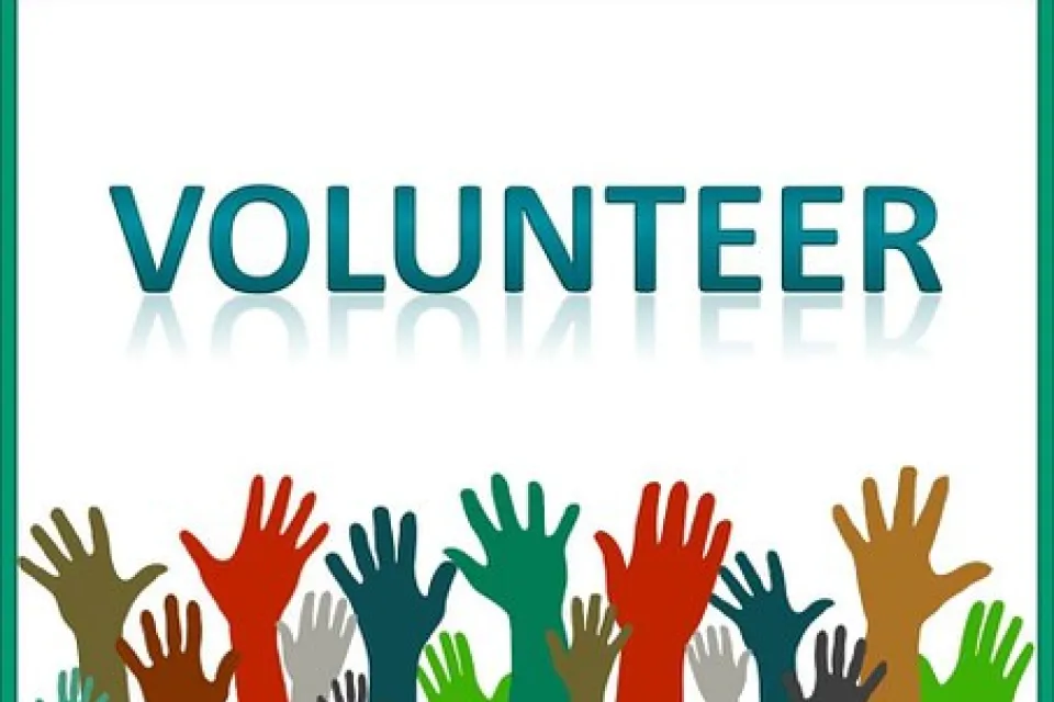 Volunteer and hands raised