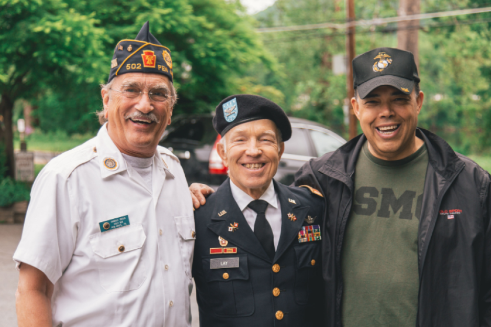 Three veteran men, standing for photo