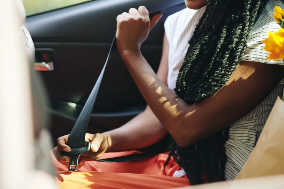 Woman fastening seat belt
