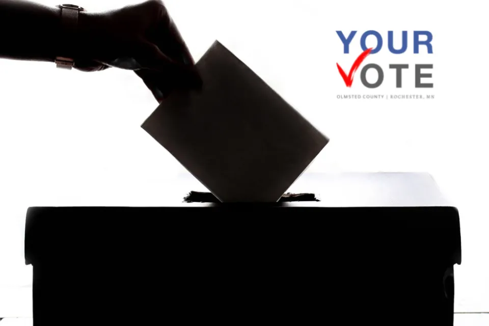 A ballot being placed into a ballot box. Your Vote Olmsted County/Rochester logo in the upper right corner.