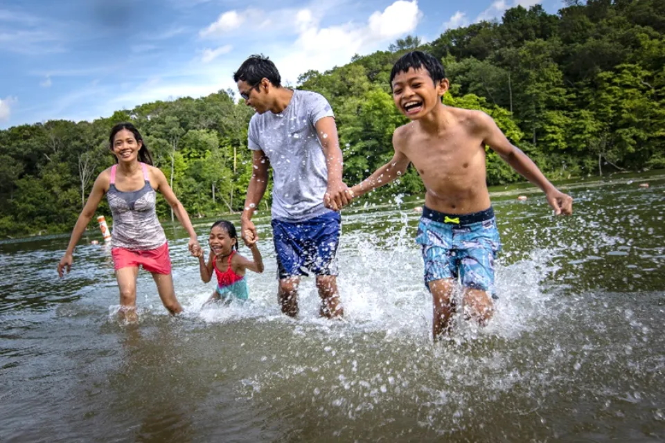 a family playing in the water at a beach