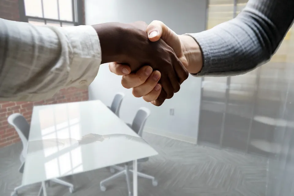 Close up of two individuals shaking hands