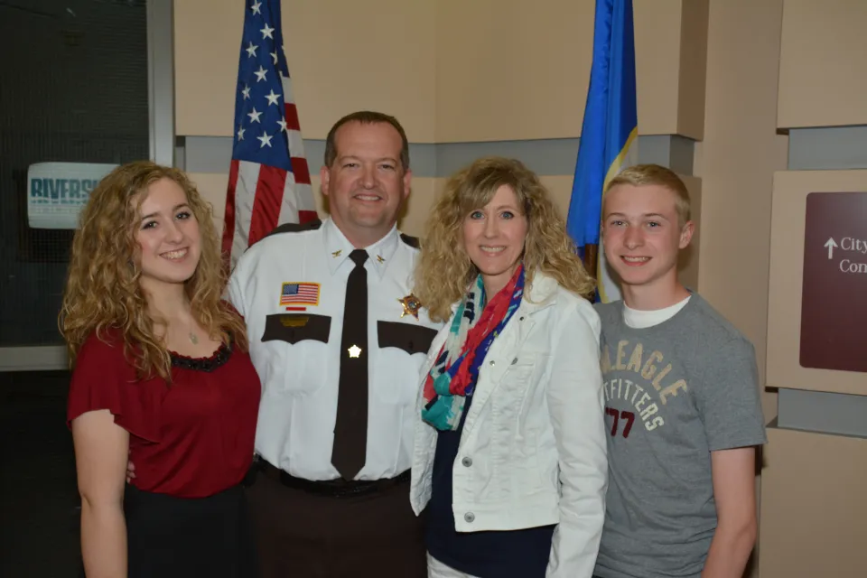 Brian Howard and his family pose for a photo following a promotion