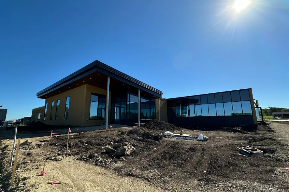 A portion of the Public Works Service building under construction with the sun shining down on it.
