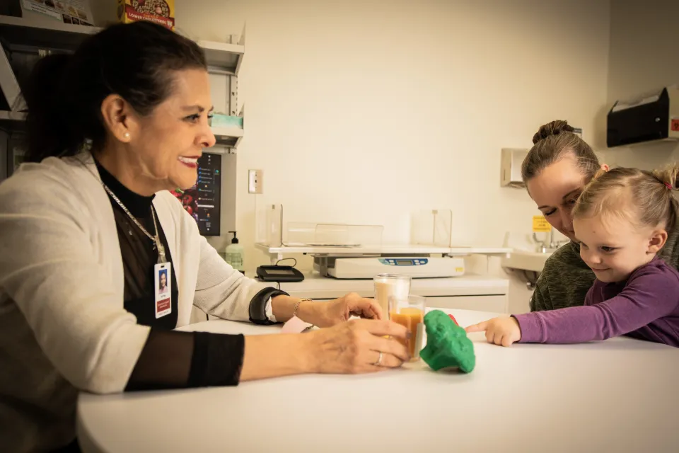 WIC nutritionist educating a woman and her child about healthy foods