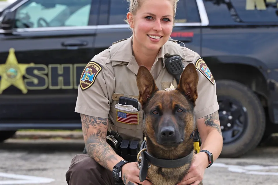 Deputy Torkelson and K9 Ragnar in front of a squad