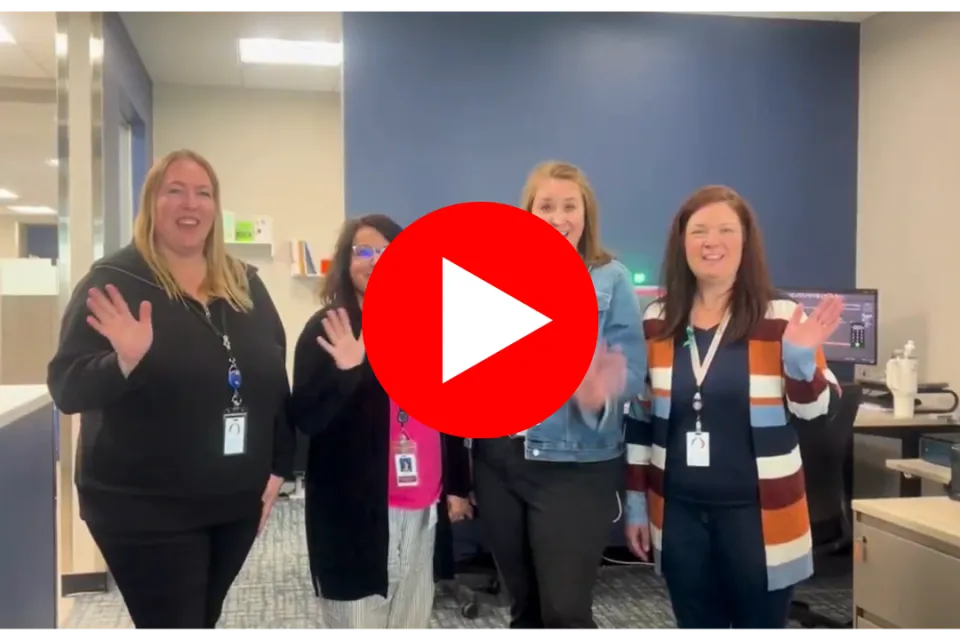 Olmsted County employees waving with a play button to watch video