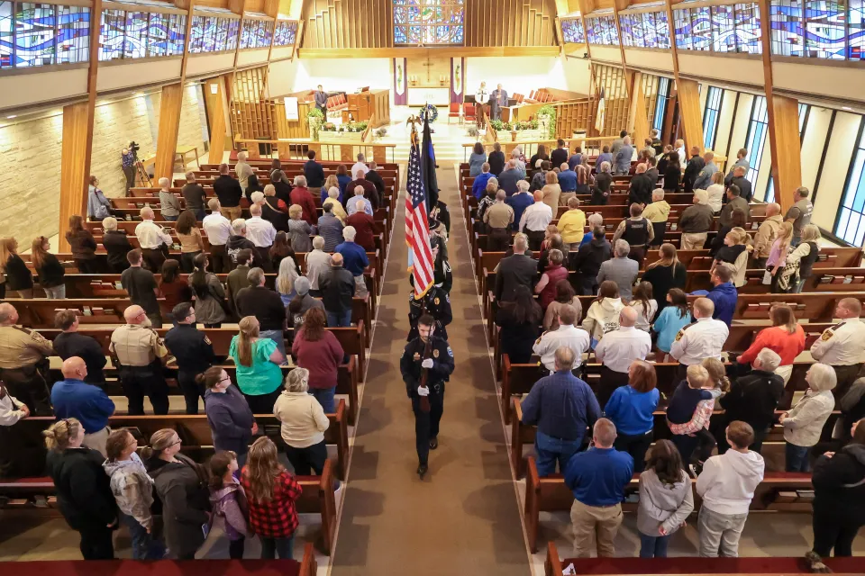 Honor Guard retrieves colors following the memorial program inside church