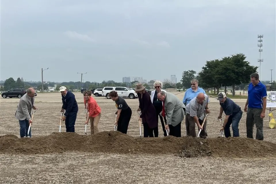 Olmsted County Board of Commissioners shoveling into pile of dirt