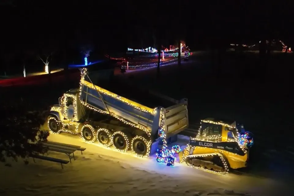 Construction vehicles lit up with holiday lights at Chester Woods Campground