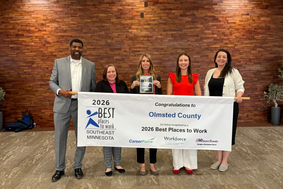 Olmsted County employees holding Best Place to Work sign