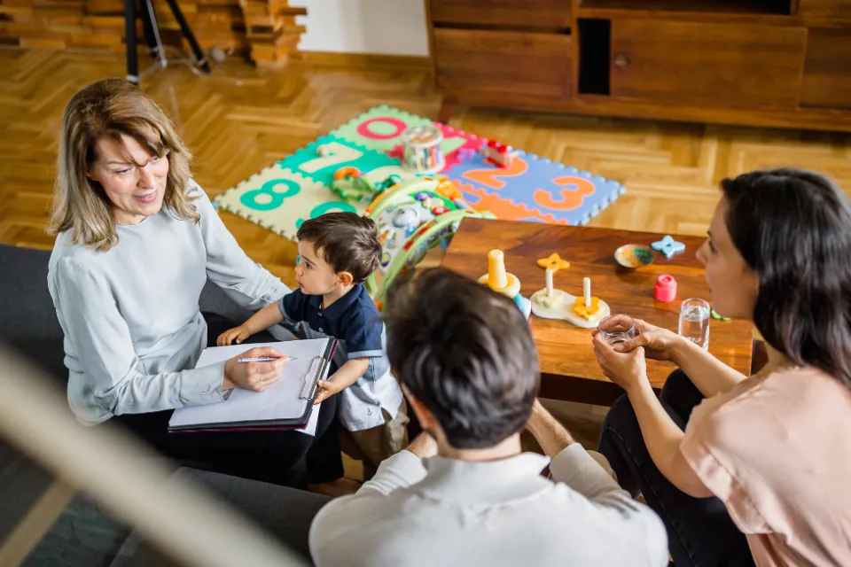 Family playing and meeting with social worker