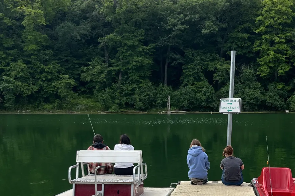 Group of people fishing off a dock