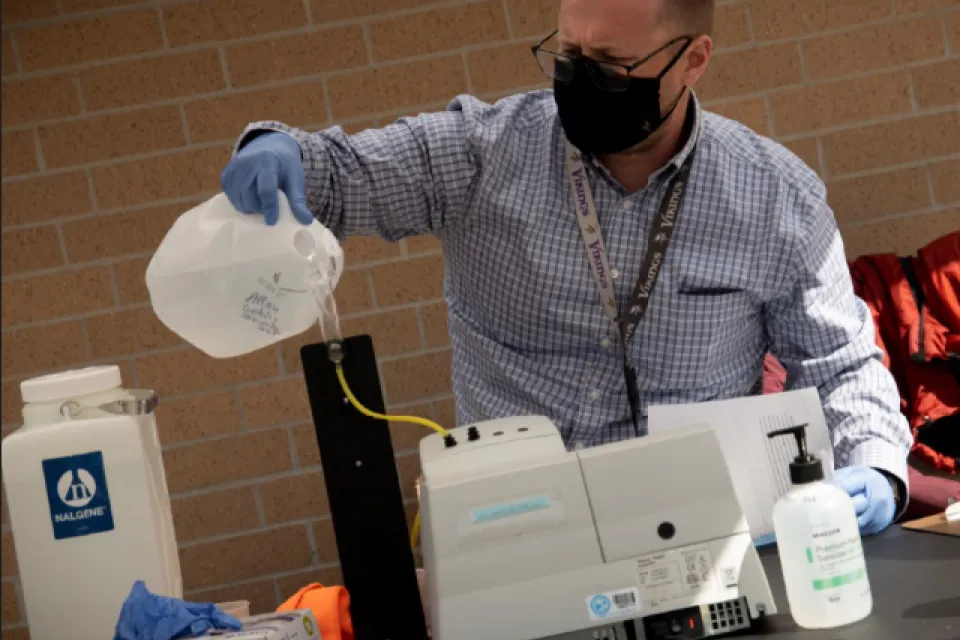 Public Health employee testing a water sample