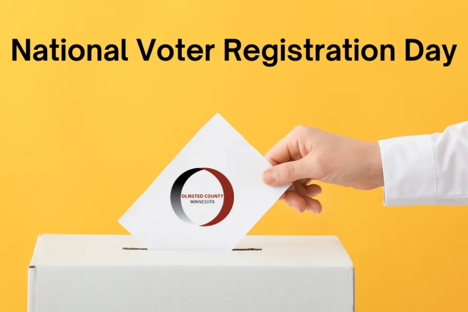 Hand putting ballot into ballot box with text National Voter Registration Day